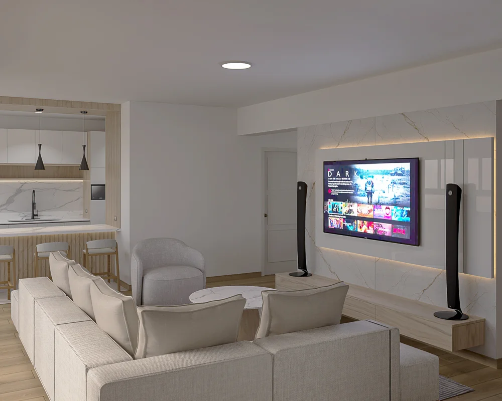 Primer plano del centro de entretenimiento con TV, parlantes y vista a la cocina.